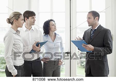 Business colleagues talking View Large Photo Image Stock Photo - Business colleagues talking. Fotosearch