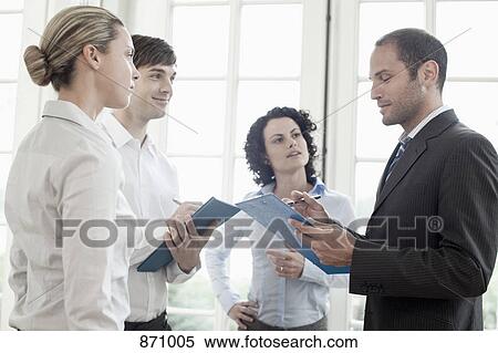 Business colleagues talking View Large Photo Image Stock Photography - Business colleagues talking. Fotosearch