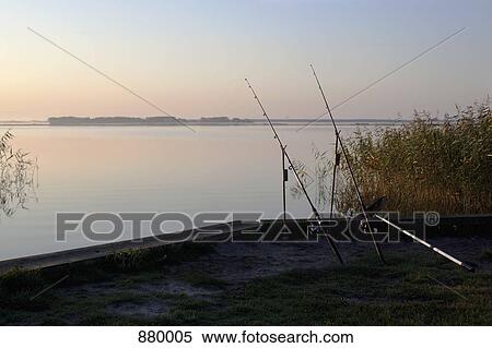 Two fishing rods on an embankment View Large Photo Image Stock Photography - Two fishing rods on an embankment. Fotosearch