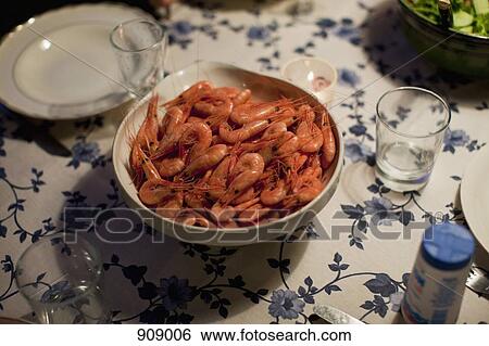 Stock Photograph - A bowl of prawns on a table. Fotosearch