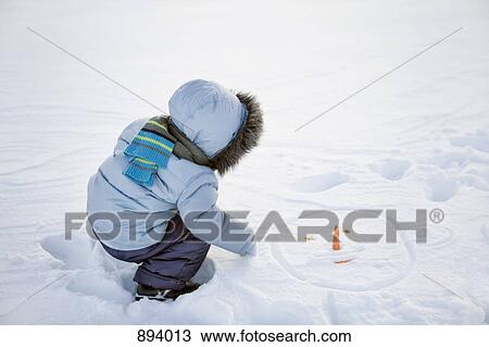 A boy playing in the snow View Large Photo Image Stock Image - A boy playing in the snow. Fotosearch