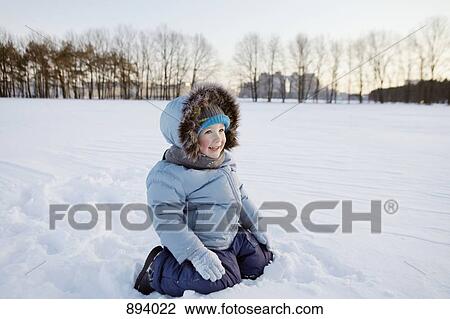 A boy playing in the snow View Large Photo Image Stock Image - A boy playing in the snow. Fotosearch
