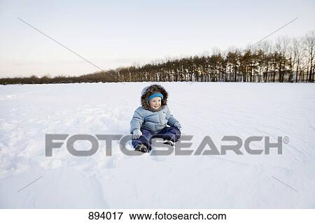 A boy playing in the snow View Large Photo Image Stock Photo - A boy playing in the snow. Fotosearch