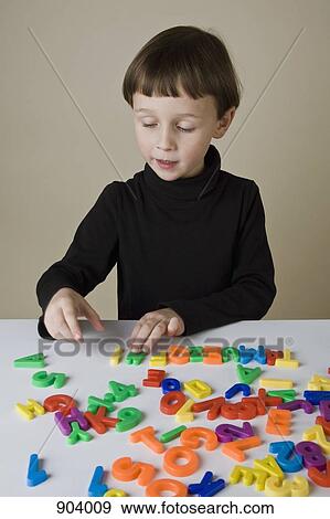 A boy playing with letter magnets View Large Photo Image Stock Photo - A boy playing with letter magnets. Fotosearch
