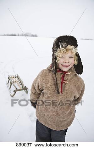 A boy pulling a sled View Large Photo Image Stock Photo - A boy pulling a sled. Fotosearch