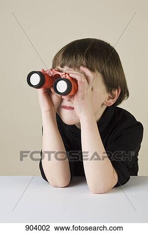 Stock Image - A boy using binoculars. Fotosearch
