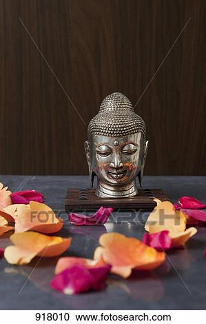 A Buddha head statue and rose petals View Large Photo Image Stock Image - A Buddha head statue and rose petals. Fotosearch