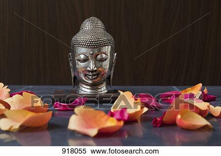 A Buddha head statue and rose petals View Large Photo Image Stock Photography - A Buddha head statue and rose petals. Fotosearch