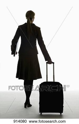 A businesswoman pulling a wheeled carry on and holding a portfolio View Large Photo Image Stock Image - A businesswoman pulling a wheeled carry on and holding a portfolio. Fotosearch