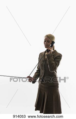 A businesswoman using a landline phone View Large Photo Image Stock Image - A businesswoman using a landline phone. Fotosearch