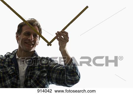 A carpenter using a folding ruler View Large Photo Image Stock Image - A carpenter using a folding ruler. Fotosearch