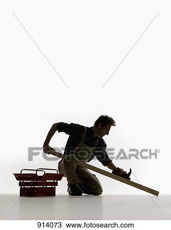 A carpenter using a plane on a plank of wood View Large Photo Image Stock Image - A carpenter using a plane on a plank of wood. Fotosearch