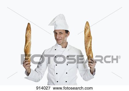 A chef holding two baguettes, portrait View Large Photo Image Stock Photo - A chef holding two baguettes, portrait. Fotosearch