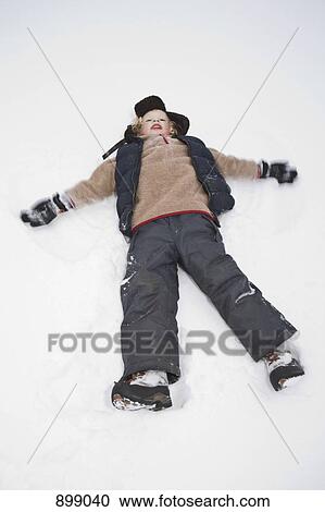 Stock Image - A child making a snow angel. Fotosearch