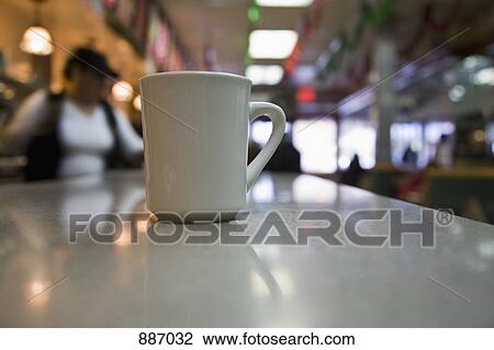Stock Image - A coffee cup on a diner counter. Fotosearch