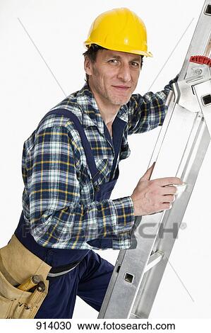 A construction worker climbing a ladder View Large Photo Image Stock Image - A construction worker climbing a ladder. Fotosearch