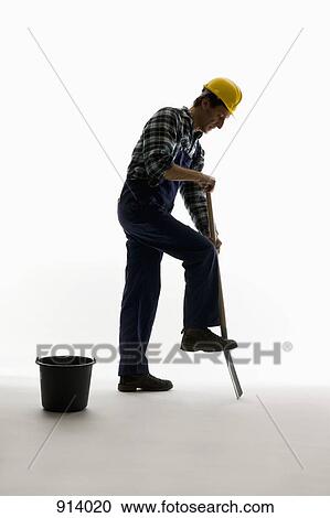 A construction worker digging with a shovel View Large Photo Image Stock Image - A construction worker digging with a shovel. Fotosearch