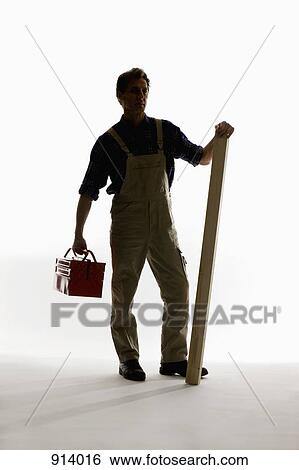 A construction worker holding a toolbox and plank View Large Photo Image Stock Photograph - A construction worker holding a toolbox and plank. Fotosearch