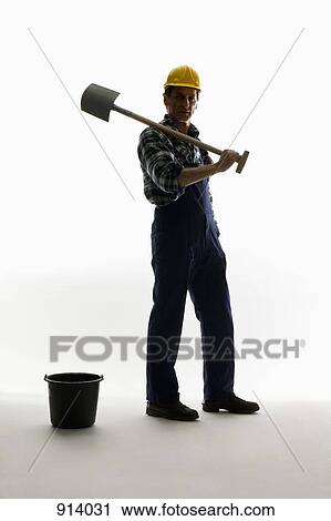 A construction worker posing with a shovel and bucket View Large Photo Image Stock Image - A construction worker posing with a shovel and bucket. Fotosearch