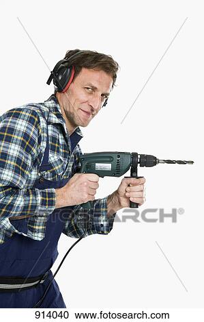 A construction worker using a drill View Large Photo Image Stock Image - A construction worker using a drill. Fotosearch