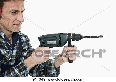 Stock Photo - A construction worker using a drill. Fotosearch