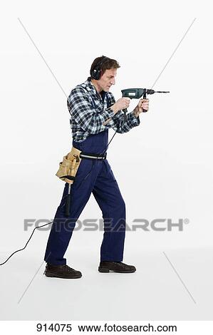 Stock Photography - A construction worker using a drill. Fotosearch
