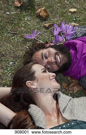 A couple lying in the grass View Large Photo Image Stock Image - A couple lying in the grass. Fotosearch