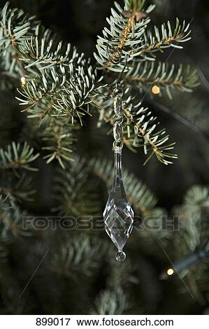 A Crystal Icicle Ornament Hanging From A Tree Branch Stock Photo