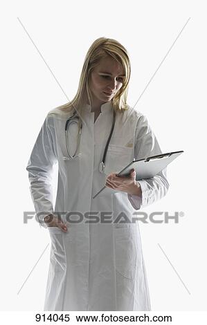 A doctor looking at a clipboard View Large Photo Image Stock Photography - A doctor looking at a clipboard. Fotosearch