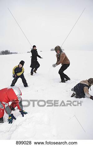 Stock Photo - A family of five having a snowball fight. Fotosearch