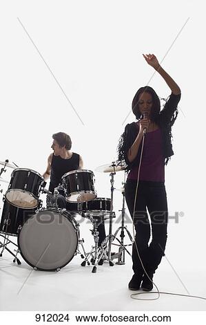 A female singer and a drummer performing, studio shot, white background, back lit View Large Photo Image Picture - A female singer and a drummer performing, studio shot, white background, back lit. Fotosearch