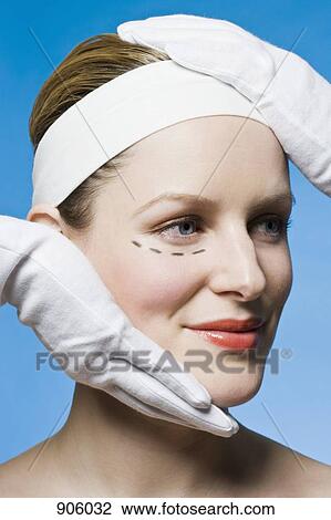A healthcare worker, detail of hands, preparing a woman for plastic surgery, headshot View Large Photo Image Stock Image - A healthcare worker, detail of hands, preparing a woman for plastic surgery, headshot. Fotosearch