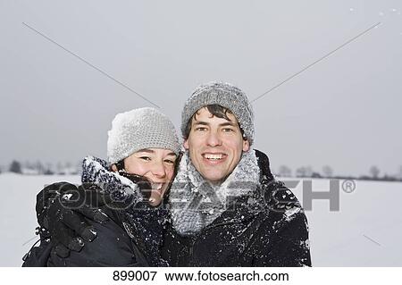 A heterosexual couple embracing, outdoors, portrait View Large Photo Image Stock Photo - A heterosexual couple embracing, outdoors, portrait. Fotosearch