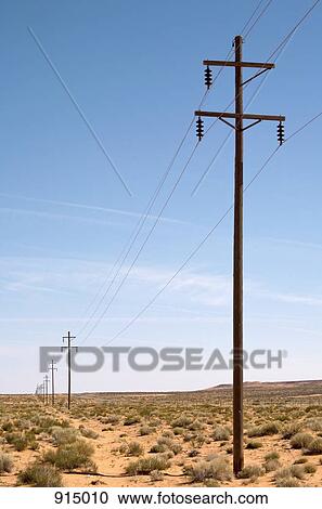 A line of utility poles in the desert View Large Photo Image Stock Image - A line of utility poles in the desert. Fotosearch