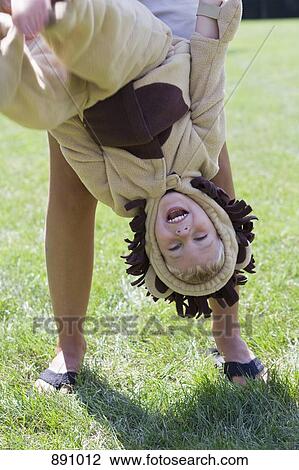 A little boy in a lion costume being held upside down by an adult View Large Photo Image Stock Image - A little boy in a lion costume being held upside down by an adult. Fotosearch
