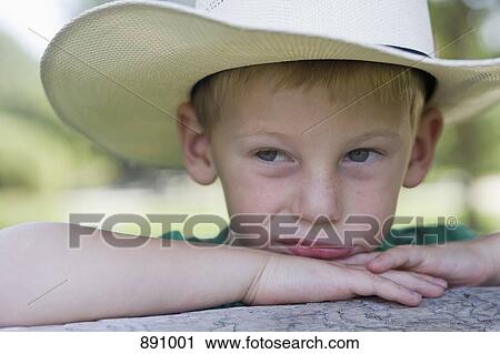A little boy wearing a cowboy hat with an upset facial expression View Large Photo Image Stock Image - A little boy wearing a cowboy hat with an upset facial expression. Fotosearch