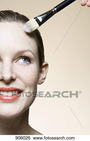 A make-up artist applying face powder View Large Photo Image Stock Photograph - A make-up artist applying face powder. Fotosearch