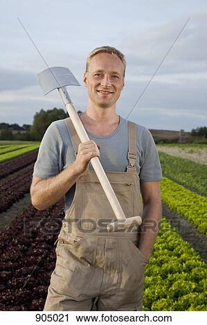 A man carrying a shovel on his shoulder View Large Photo Image Stock Image - A man carrying a shovel on his shoulder. Fotosearch