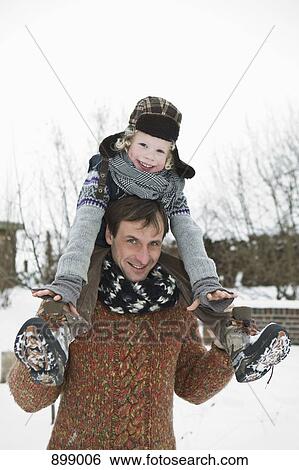 A man carrying his son on his shoulders View Large Photo Image Stock Photograph - A man carrying his son on his shoulders. Fotosearch