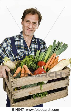 Stock Photo - A man delivering organic groceries. Fotosearch
