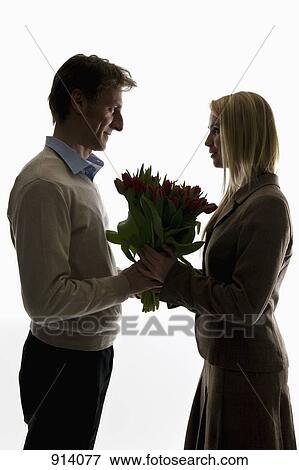 A man giving a bouquet of tulips to his girlfriend View Large Photo Image Stock Photo - A man giving a bouquet of tulips to his girlfriend. Fotosearch