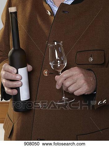 A man holding a bottle and glass of Schnapps View Large Photo Image Stock Image - A man holding a bottle and glass of Schnapps. Fotosearch