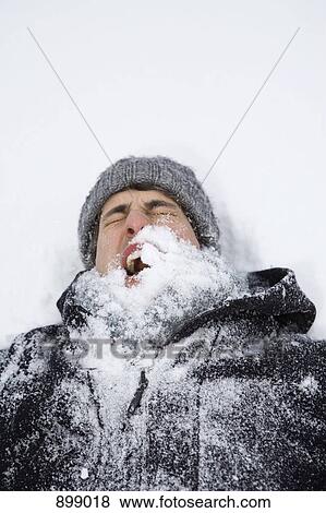 A man lying on back after being hit with a snowball, head and shoulders View Large Photo Image Stock Photo - A man lying on back after being hit with a snowball, head and shoulders. Fotosearch