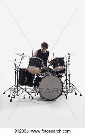 A man on drums performing, studio shot, white background, back lit View Large Photo Image Stock Photography - A man on drums performing, studio shot, white background, back lit. Fotosearch