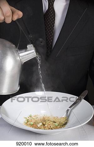 A man pouring water onto instant soup powder in a bowl View Large Photo Image Stock Image - A man pouring water onto instant soup powder in a bowl. Fotosearch