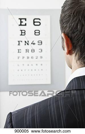 A man reading an eye chart, over the shoulder view View Large Photo Image Stock Photography - A man reading an eye chart, over the shoulder view. Fotosearch