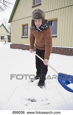 Stock Photograph - A man shoveling snow . Fotosearch