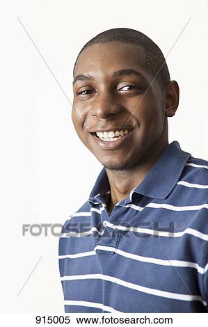Stock Photography - A man smiling, studio shot. Fotosearch