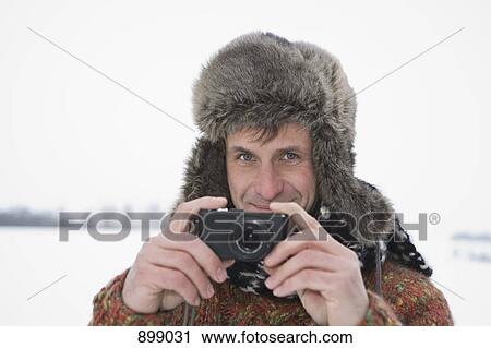 A man taking a picture with a digital camera, outdoors, portrait View Large Photo Image Stock Image - A man taking a picture with a digital camera, outdoors, portrait. Fotosearch