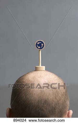 A man with a miniature roundabout road sign on his head View Large Photo Image Picture - A man with a miniature roundabout road sign on his head. Fotosearch